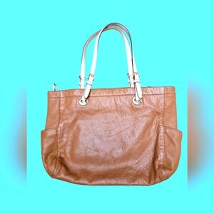 Elegant Tan Leather Michael Kors Tote Bag with side pockets.